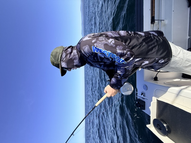 Guest enjoying a day of fishing aboard the charter boat