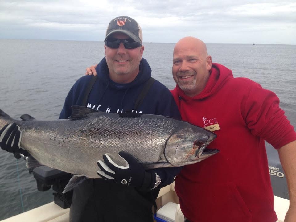Guests with a salmon caught on a Live Life Coastal private charter